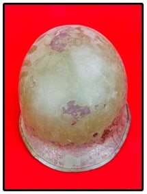 US M1 Helmet: United States M1 helmet which was the classic helmet used by the US military from WW2 through the Vietnam War. This specimen has a couple dents at side, shows wear and lacks its liner as shown. Two Fe