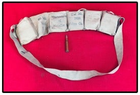 Model 1898 Cloth Ammunition Belt w Ammo: Model 1898 cloth ammunition belt with ammunition. Ammunition belt is marked The Union Metallic Cartridge Company. Belt is ink stamped with the date of 1907. Condition - some wear and soil but generall