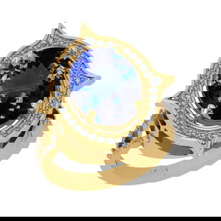 7.70 Ctw VS/SI1 Tanzanite And Diamond 18k Yellow Gold Cocktail Ring: Center Stone Weight : 7.26 Ctw (Oval Cut ) Center Stone Color : Tanzanite Stone Setting : Prong Side Stone Weight Of Ctw 0.44 Ctw Side Stone Color : J-K Stone Clarity : VS/SI1 Stone Setting : Prong