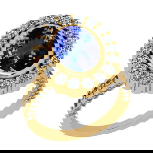 5.85 Ctw VS/SI1 Tanzanite And Diamond 18k Yellow Gold Cocktail Ring: Center Stone Weight : 4.15 Ctw (Oval Cut ) Center Stone Color : Tanzanite Stone Setting : Prong Side Stone Weight Of Ctw 1.70 Ctw Side Stone Color : J-K Stone Clarity : VS/SI1 Stone Setting : Prong Me