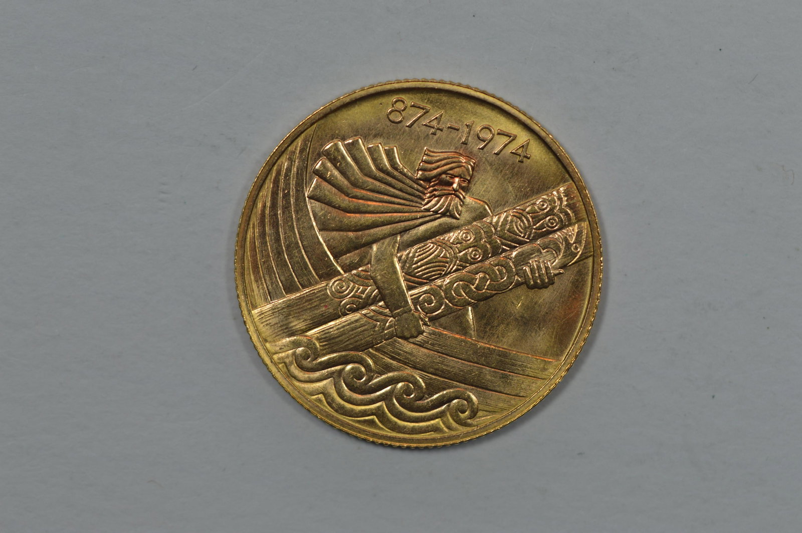 Iceland 1974 Gold 10,000 Kronur: Iceland 1974 Gold 10,000 Kronur (KM-22, .4485 oz AGW). Appearance of Ch BU but revealing light hairlines on either side. From a mintage of 12,000 business strikes. Est. $675.