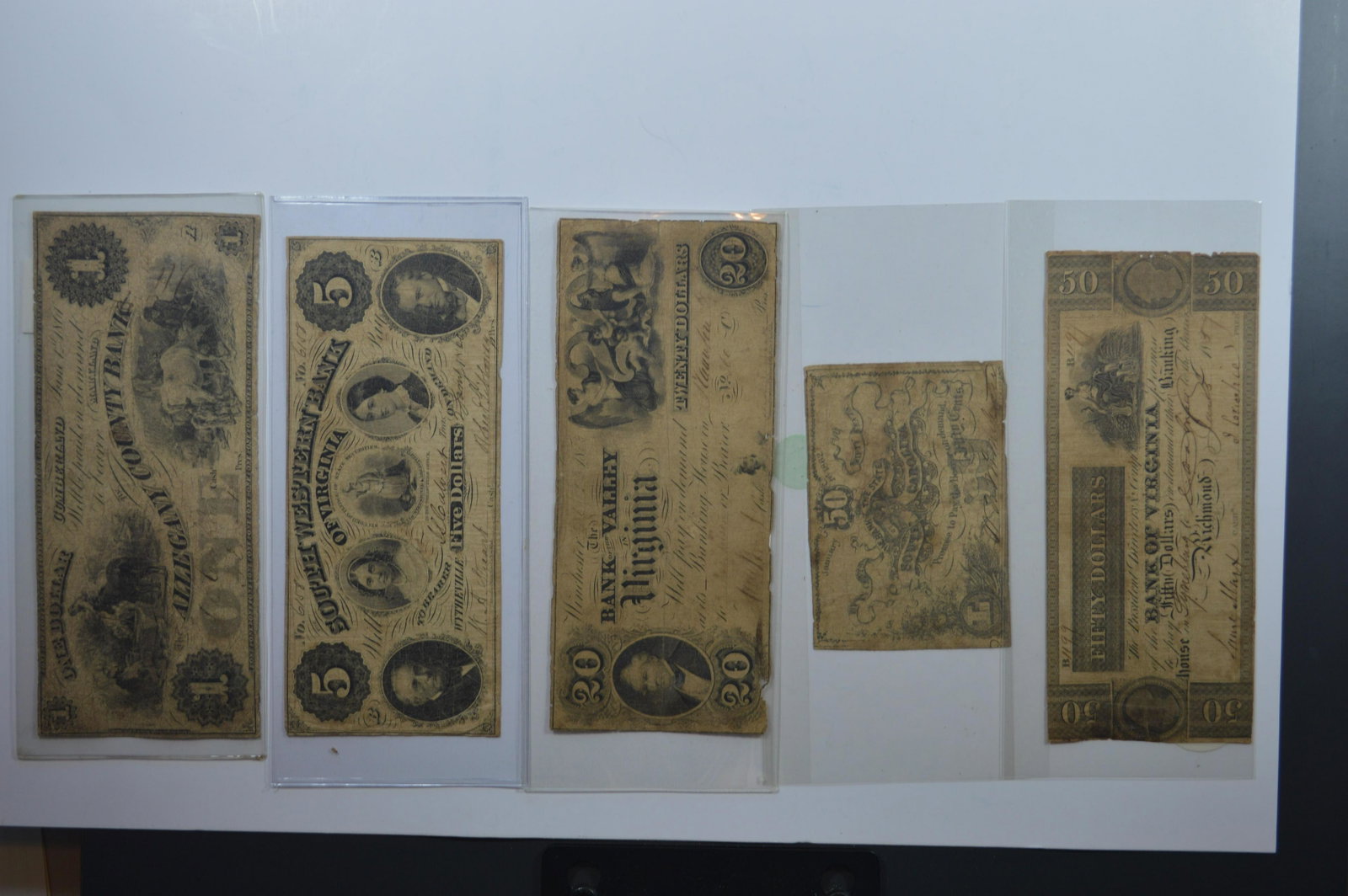 A Circa 1860 Mostly Southern Obsolete Banknote: A Circa 1860 Mostly Southern Obsolete Banknote Grouping comprised of: Maryland, $1.00 The Allegany County Bank; South Carolina, 50c Bank of the State of South Carolina; Virginia, $20.00 Bank of the Va