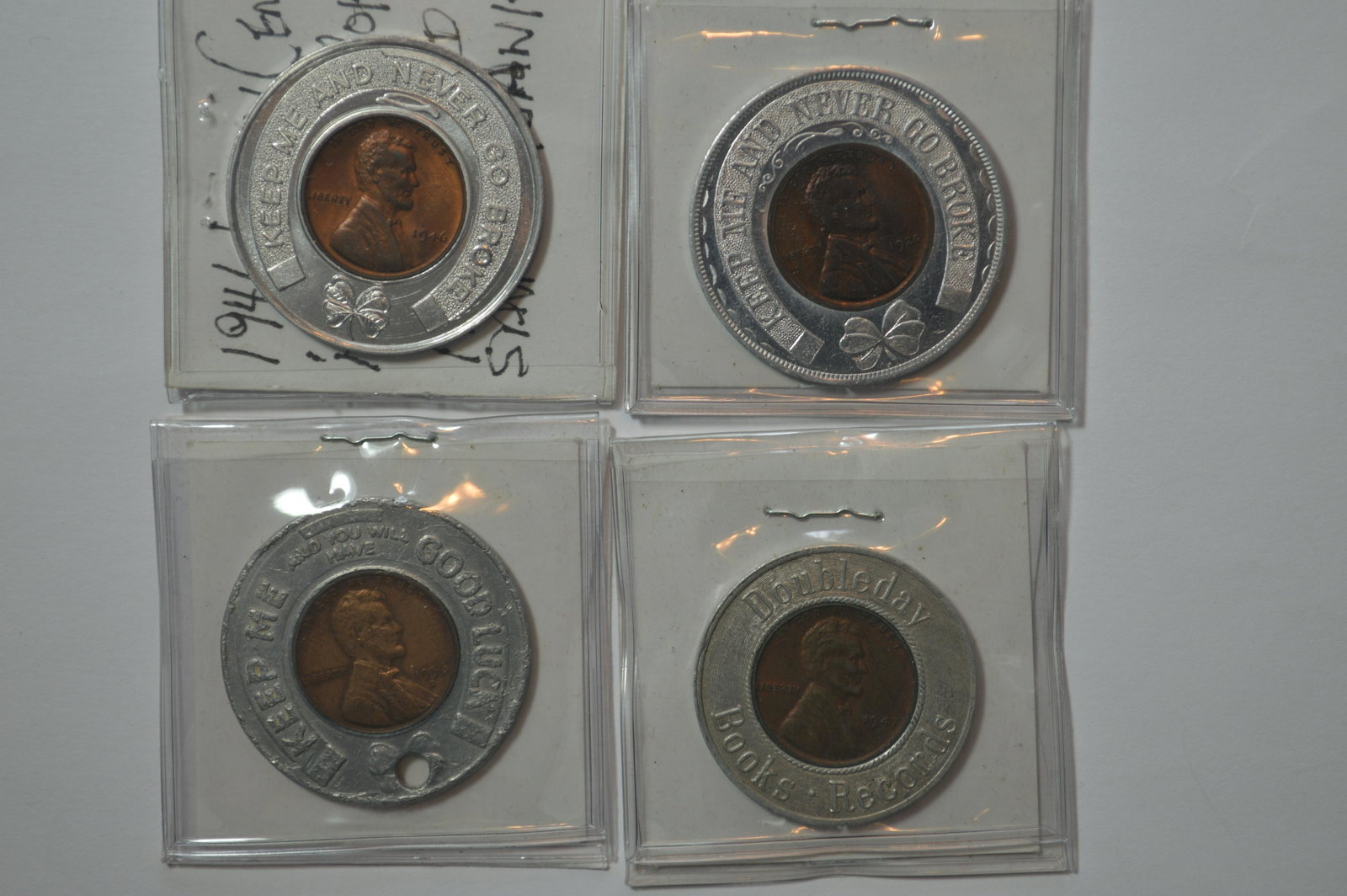 A Quartet of New York City and Related Area Encased Cen: A Quartet of New York City and Related Area Encased Cents, all of which bear a Wheat cent. Included are Ridgewood Savings Bank; Savings Bank of Ridgewood; Jamaica Loan Company (holed); Doubleday Books
