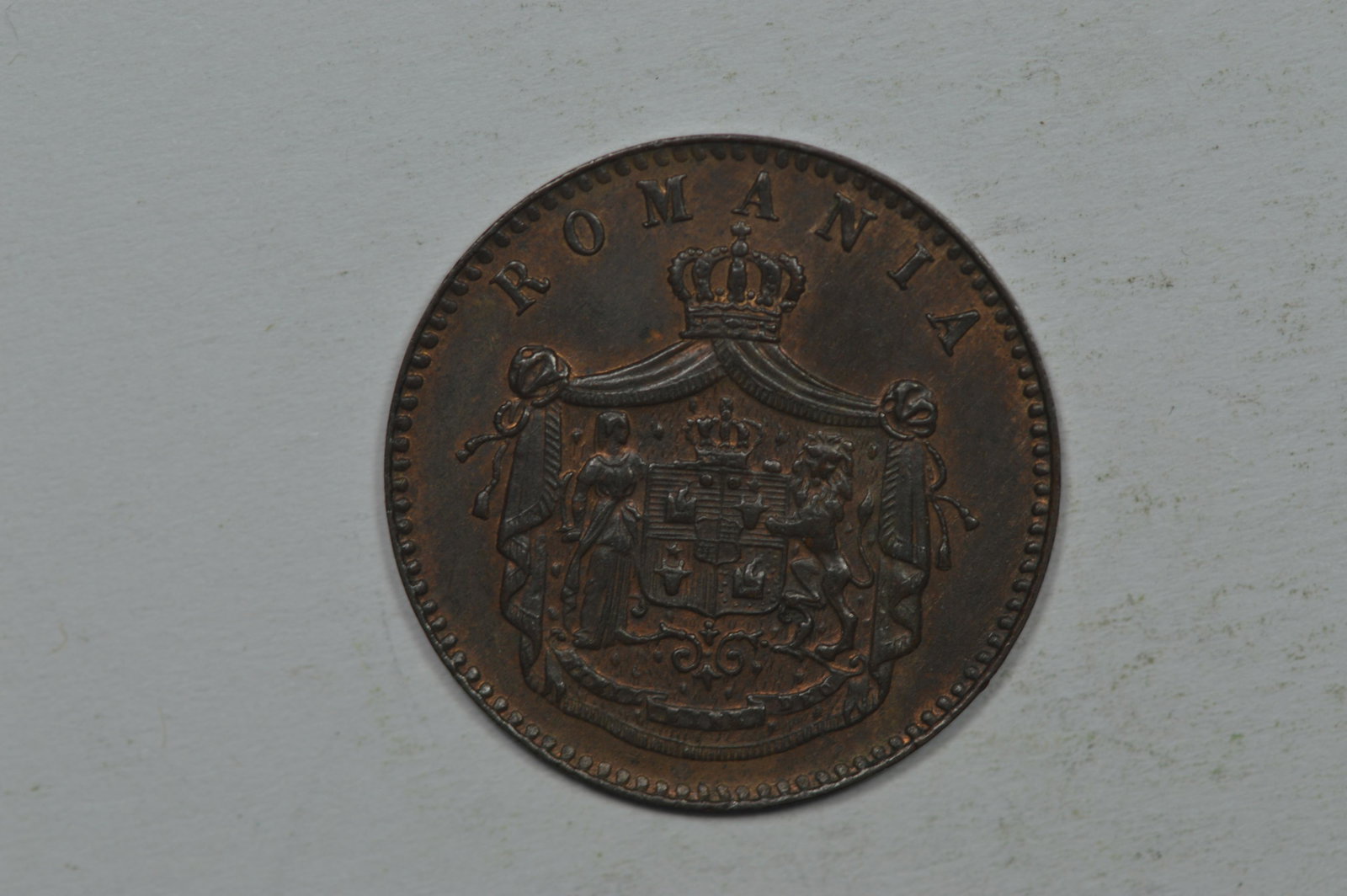Romania 1867 Two Bani. Struck by Watt & Co (KM2.2). EF: Romania 1867 Two Bani. Struck by Watt & Co (KM2.2). EF or better and still enjoying traces of faded mint color amidst some light surface deposits. The EF40 catalogue value in KM is $35.