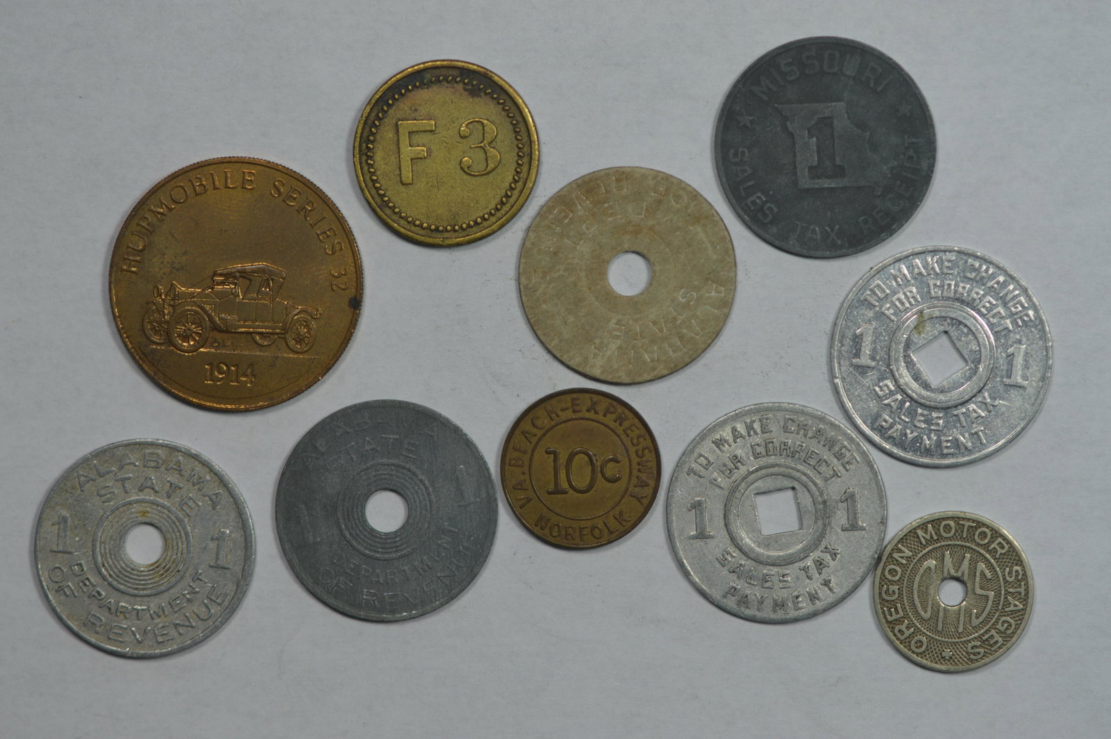 A Small U.S. Token Assortment, heaviest in sales tax to: A Small U.S. Token Assortment, heaviest in sales tax tokens. There are a total of 10 pieces, and we see only two duplicates.
