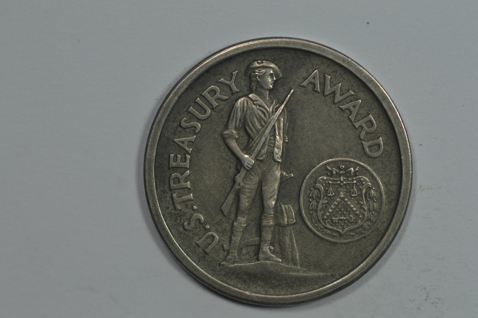 1941-1945 U.S. Treasury Award (21.5 grams). The obverse: 1941-1945 U.S. Treasury Award (21.5 grams). The obverse depicts a Minuteman; the reverse bears the legend FOR PATRIOTIC SERVICE and WAR FINANCE. These medals apparently were issued to those that parti