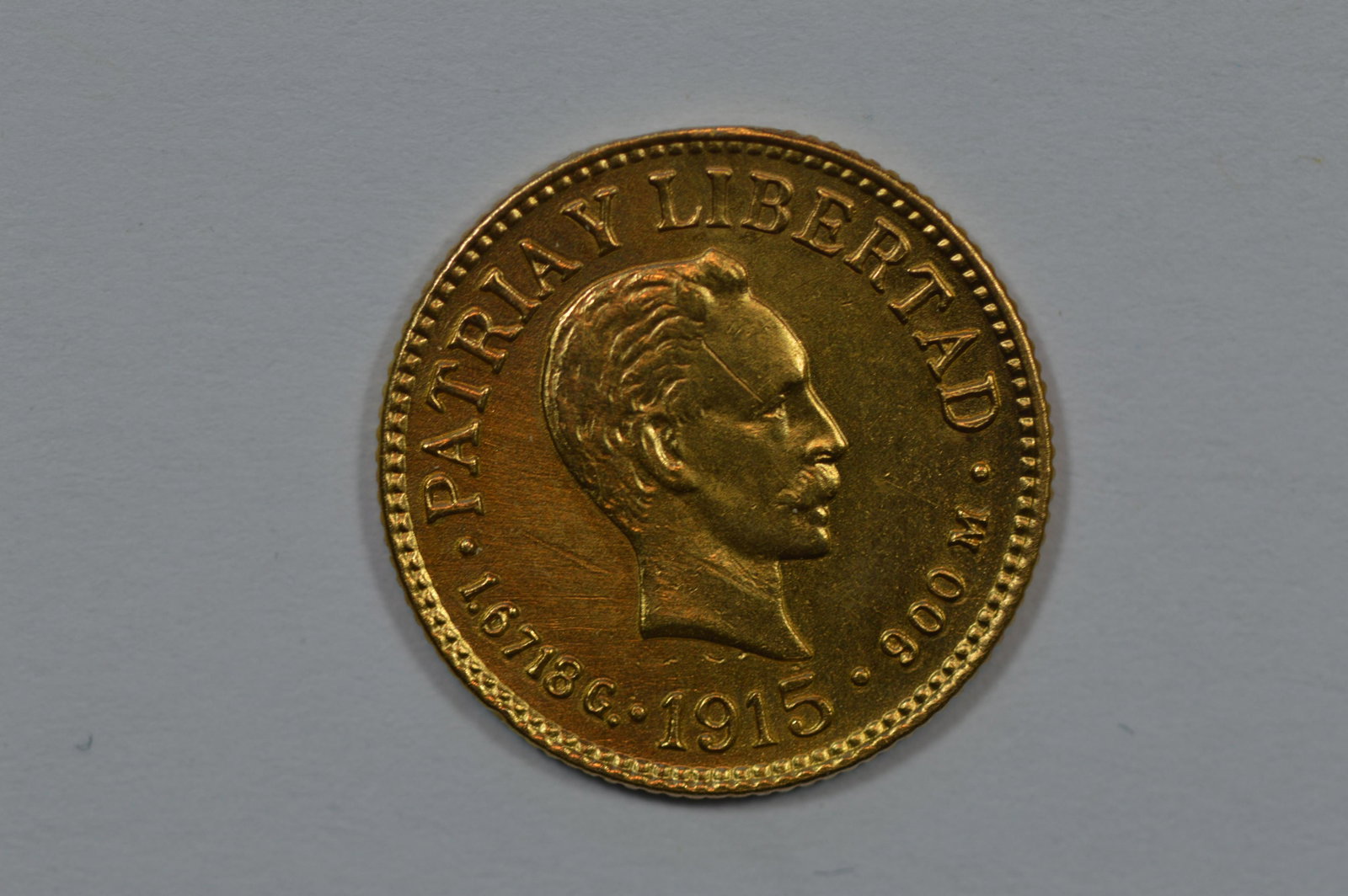 Cuba 1915 Gold Peso (KM-16, .0484 oz AGW): Cuba 1915 Gold Peso (KM-16, .0484 oz AGW). EF Detail. Burnished and showing solder remnants on the edge. Est. $75.