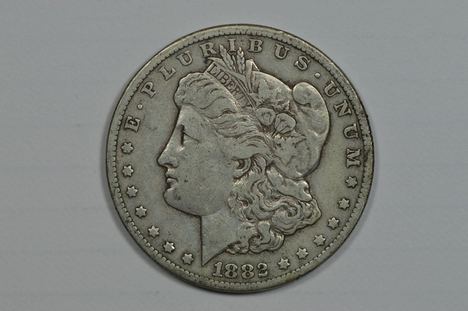 $1.00 Silver 1882-CC: $1.00 Silver 1882-CC VF and an evenly worn example of this Carson City Mint scarcity. Est. $130.