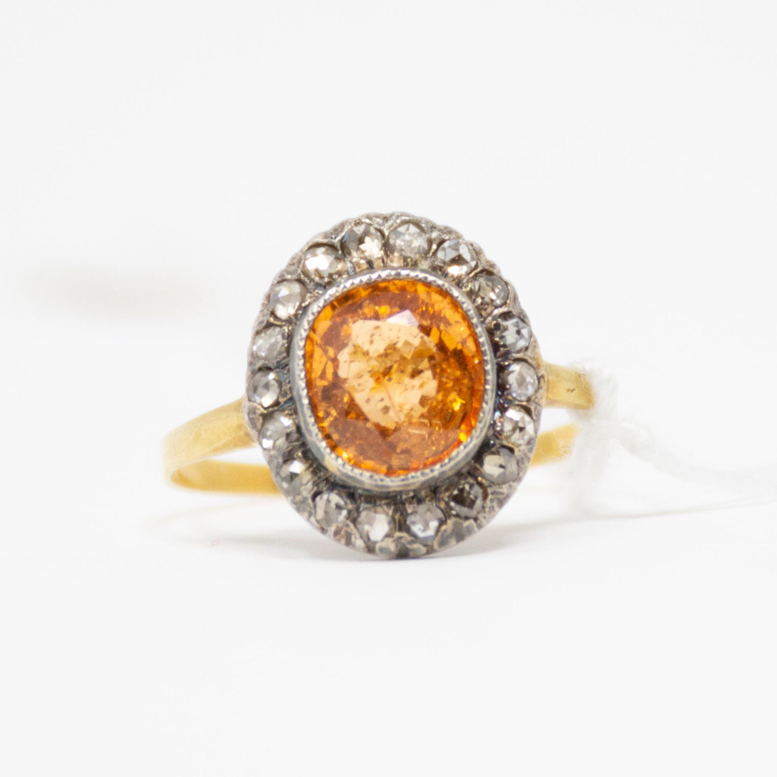 18KT Victorian Mandarin Garnet and Diamond Ring: The vibrant madarin spessartite garnet is bezel set in the center and weights approx 2.00cts. There are 18 Old rose cut diamonds set on aged silver victorian style. The diamond weight is approx .40cts
