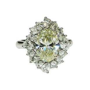 Light Yellow Diamond Solitaire Ring: Metal: 18KW Weight: 8.02 Grams Stone: Yellow Diamond, White Diamond Carat: 3.02ctw Yellow, 1.33 White Description: Estate 3.02ctw yellow diamond oval cut center that measures 10.6x7.8mm.