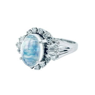 Opal And Diamond Ring: Metal: Platinum Weight: 7.30 Grams Stone: Opal, Diamond Carat: 1.57ctw Opal, 0.64ctw Diamonds Description: Estate crystal opal center that measures 10x7mm with tappered baugett and round