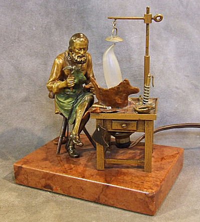 Vienna bronze figurine of a cobbler at workbench, : Vienna bronze figurine of a cobbler at workbench, marked "Gesetz. Gesch. #898". Electrified lamp and mounted on marble base. 6" high, marble base 3.75" X 5.25"