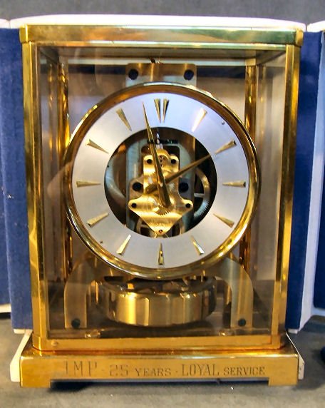Le Coultre Atmos clock with original case in runni: Le Coultre Atmos clock with original case in running order, 15 jewel movement #72432. Engraved "J.M.P. - 25 Years - Loyal Service". Minor spotting on dial, lacquer worn on case. 8.75" high, 7" wide.