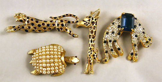 4 pieces estate costume jewelry figural pins, Trifa: 4 pieces estate costume jewelry figural pins, Trifari turtle with movable head 2", K.J.L. panther, JOMAZ giraffe 2.5" and Ciner running leopard 2.75". All in excellent condition with no missing stones