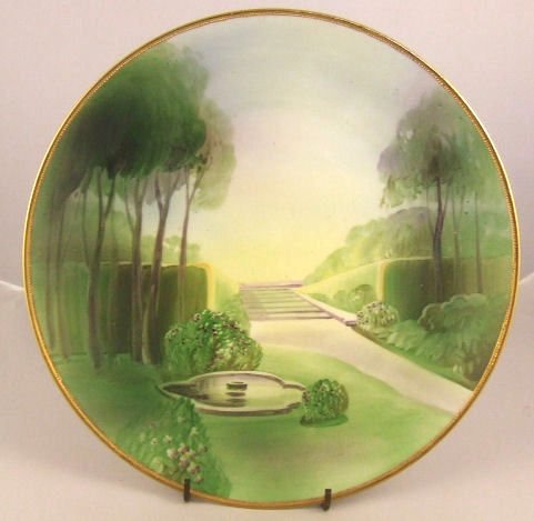 Nippon porcelain wall plaque, garden scene with fou: Nippon porcelain wall plaque, garden scene with fountain, 10.25" dia. Excellent condition with minor gold wear on edge.