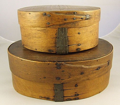 Two oval pantry / storage boxes, splits, edge of l: Two oval pantry / storage boxes, splits, edge of lid on smaller has piece missing. 10.5" X 8.5" X 4" and 8" X 7" X 3.5"