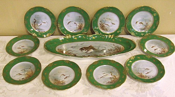 Theodore Haviland Limoges 11pc. Fish set, 10 - 9": Theodore Haviland Limoges 11pc. Fish set, 10 - 9" plates and 23 1/4" platter, hand painted centers with gold decorated borders. Flake to edge of one plate, minor stacking wear.