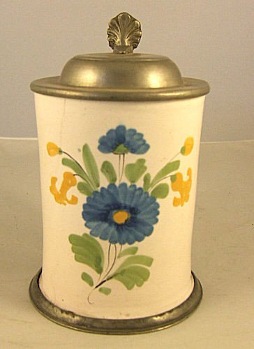 Early German Faience stein with floral decoration,: Early German Faience stein with floral decoration, pewter foot ring loose, pewter strap around handle loose, tight hairline on side and base, 6.25" high to top of thumblift.