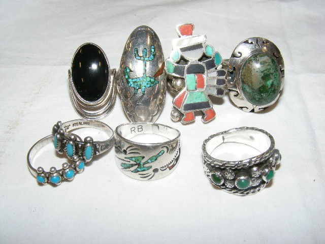 8 Native American style rings with maker marks. 2: 8 Native American style rings with maker marks. 2 small rings with arrow sign mark, bird ring marked RB. Ring with four green stones marked F.T., ring with black stone marked sterling only, Oval ring
