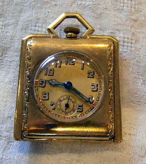 14k, marked .585 gold case pocket watch with ename: 14k, marked .585 gold case pocket watch with enameled BMW logo on the back cover, deco design, frame opens to stand watch on table, works are not marked, not running, 1.5" wide and 2" high, 53.9 grams