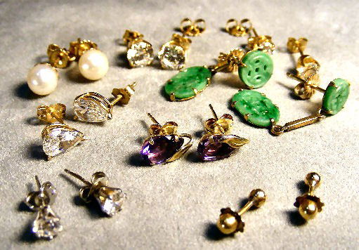 Gold earring lot. (back pieces are marked 14k). 9.: Gold earring lot. (back pieces are marked 14k). 9.9 grams total weight.