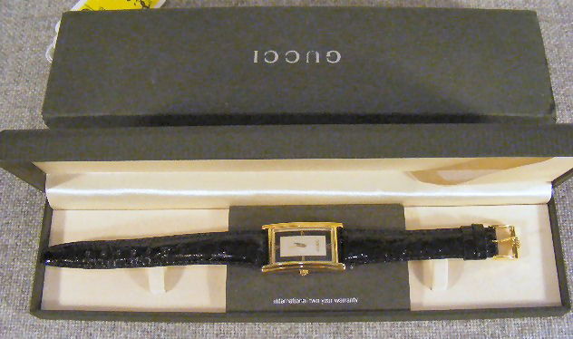Pair of Gucci wristwatches with boxes & booklets.: Pair of Gucci wristwatches with boxes & booklets. 1998, Swiss made quartz moevment, gold plated. Tank style watch, 1.5" from end of lugs x 1" wide to end of crown.