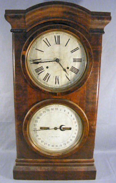 Seth Thomas mahogany calendar clock, dated 1878 o: Seth Thomas mahogany calendar clock, dated 1878 on label, upper glass on door cracked, paper dial faces, 33" high, 16.5" wide