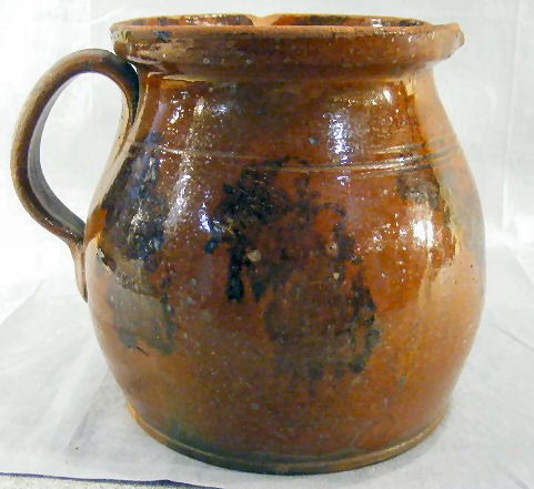 Large redware stoneware pitcher with sponge decora: Large redware stoneware pitcher with sponge decoration, chip on top edge and spout, 8.5" high, 7' wide