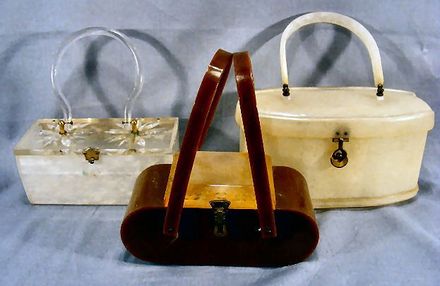 3 Lucite & plastic 1950's purses. (1 on left in 1s: 3 Lucite & plastic 1950's purses. (1 on left in 1st pictures is missing clasp part and is cracked in back). Brown 1 is complete, small chip on bottom on back and slight twist to handles. Taller white