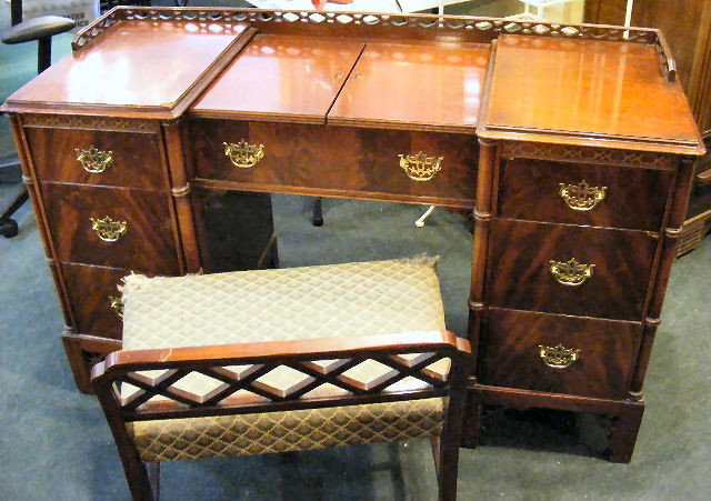Mahogany vanity & stool. Sliding top w/ hidden mi: Mahogany vanity & stool. Sliding top w/ hidden mirror. Some chips in wood & stool needs upholstery.