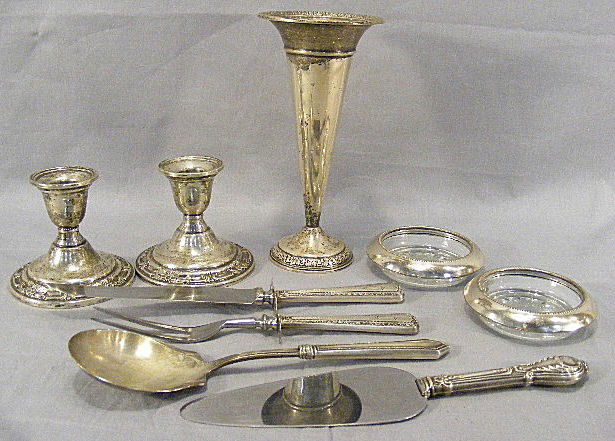 Lot of weighted sterling silver, 8" vase, pair In: Lot of weighted sterling silver, 8" vase, pair International Wild Rose candle holders, carving set and 2 serving pieces with sterling handles and two glass coasters with sterling rims.