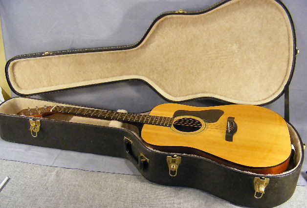 Acoustic guitar w/ case. Madeira, model # A-9 Ser: Acoustic guitar w/ case. Madeira, model # A-9 Serial #03166. 41.5" tall, repair on back.