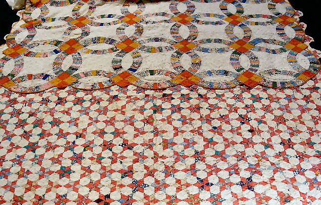 Two quilts, Star 77" X 78" and Wedding Ring 86" X: Two quilts, Star 77" X 78" and Wedding Ring 86" X 75", minor edge wear and some spots of brown staining.