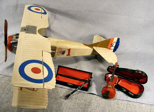 Plastic and metal bi-plane made in China with 30": Plastic and metal bi-plane made in China with 30" wingspan and miniature 6" flute and 7" violin