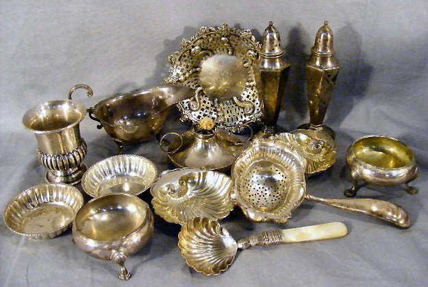 Sterling silver collection, salt/nut dishes, salt: Sterling silver collection, salt/nut dishes, salt & pepper shakers, tea strainer, reticulated dish, shell sugar spoon, creamer & burner. 16.70 ozt (does not include sugar spoon).