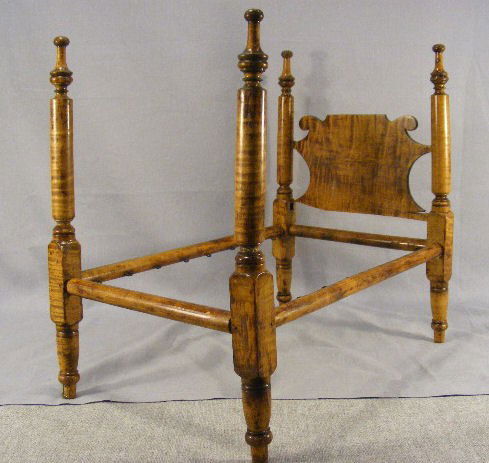 Antique tiger maple doll's tall post bed, 16.5" h: Antique tiger maple doll's tall post bed, 16.5" high, 18" long & 10.5" wide. One post broken with chip on top, breaks on headboard