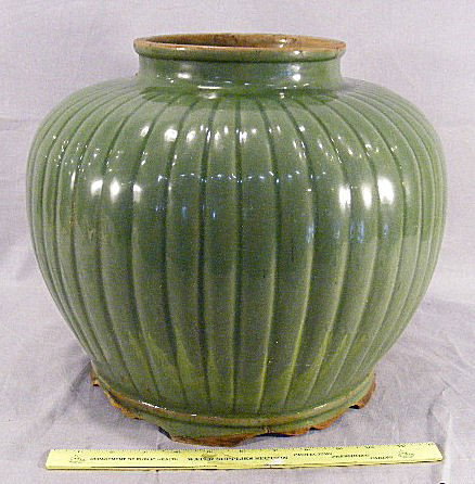 Large Asian celadon colored ribbed jar, two glaze: Large Asian celadon colored ribbed jar, two glaze flakes, chips on foot ring, 12" high, 14" wide