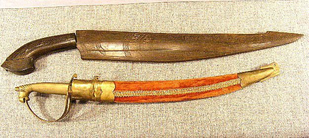 Two swords, one with 15" blade, wood scabbard ins: Two swords, one with 15" blade, wood scabbard inscribed "Philippines 1946" handle loose from tang & broken on end together with short sword with blade marked "Made in India"