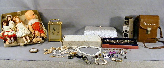 Lot including 3 vintage purses unused, battery op: Lot including 3 vintage purses unused, battery operated clock, costume jewelry, pocket watch and wristwatch as is Bell and Howell movie camera, misc. small dolls (as is).