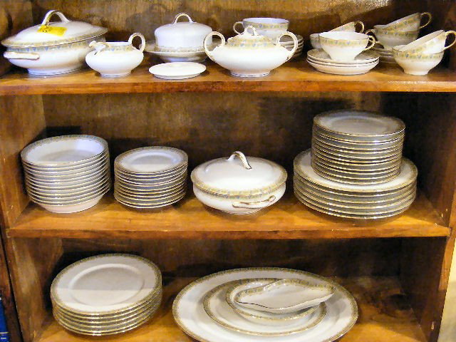 Guerin Limoges porcelain dinnerware, some wear to: Guerin Limoges porcelain dinnerware, some wear to trim, creamer & sugar bowl, 8 cups, 11 saucers, 2 covered veg. bowls, covered butter, two platters, celery dish, 12- 10.25" plates, 12 - 7.25" soup bo