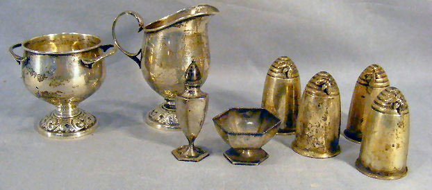 Sterling hollow ware, cream & sugar, salt seller &: Sterling hollow ware, cream & sugar, salt seller & shaker, ( 7.60 OZT). Four glass lined shakers, made by Gorham and there are sterling flies on them.