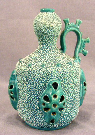 Zsolnay pitcher with pierced decoration and pebble: Zsolnay pitcher with pierced decoration and pebbled surface, impressed mark and numbered 1379, 8"high, no chips or cracks