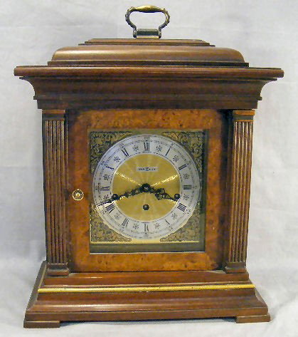 Howard Miller shelf clock, 142H triple chime, key: Howard Miller shelf clock, 142H triple chime, key wind movement, not running, 19" high, 14" wide.