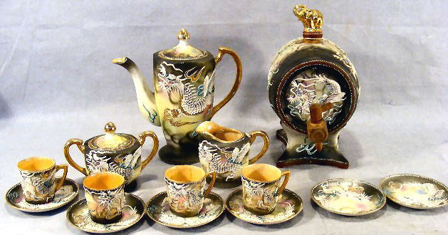 Lot of Japanese dragon ware china including Sake b: Lot of Japanese dragon ware china including Sake barrel (cork broken), tea pot, creamer, sugar bowl, 4 cups, 6 saucers. One cup cracked, sugar with small chip on inner top edge