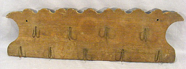 Antique wall mounted wooden game board / 9 hooks : Antique wall mounted wooden game board / 9 hooks with scalloped top edge. 9" x 30.5".
