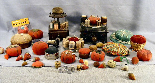 Lot of sewing pincushions including figural dachs: Lot of sewing pincushions including figural dachshund, Victorian silver plate, tomatoes, strawberries, basket, etc., metal thimbles, thimble basket, two sewing boxes, etc.