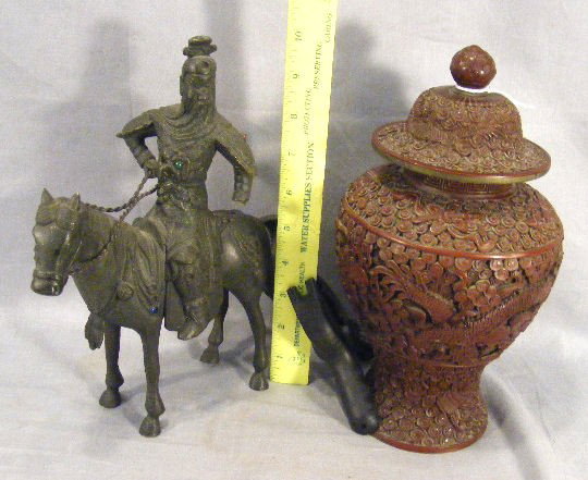 2pcs. Chinese cinnabar urn, very ornate, damaged,: 2pcs. Chinese cinnabar urn, very ornate, damaged, missing sections, chip in lid & finial separating, 10" tall. Bronze Chinese soldier on horse back, jewels in armor, (some missing and left hand is mis