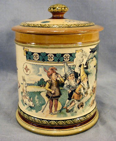 Mettlach print under glaze tobacco jar, 7.5" high,: Mettlach print under glaze tobacco jar, 7.5" high, 5.25" wide at base 2268/1047, repaired lid and three tight line on top edge