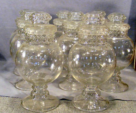 8 store / apothecary pressed glass jars, 12" high : 8 store / apothecary pressed glass jars, 12" high to top of stopper, early 20th century, four jar top edges chipped, two stopper edges chipped
