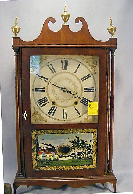 Eli Terry pillar & scroll clock, original label, m: Eli Terry pillar & scroll clock, original label, mahogany case, reproduction finials, 29" high to top of scroll